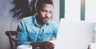 Man using laptop to research federal financial support during COVID-19